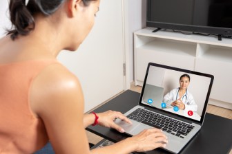 Patient using live-interactive teledermatology to speak with a doctor