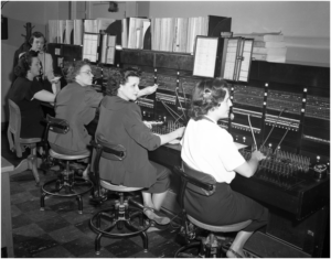 Telephone Switchboard with Operators, photograph, January 15, 1950; (texashistory.unt.edu/ark:/67531/metapth40667/m1/1/: accessed October 20, 2016), University of North Texas Libraries, The Portal to Texas History, texashistory.unt.edu; crediting Lockheed Martin Aeronautics Company, Fort Worth TX.